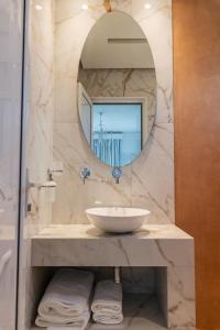a bathroom with a sink and a mirror at Studios Filipidis in Chrysi Ammoudia