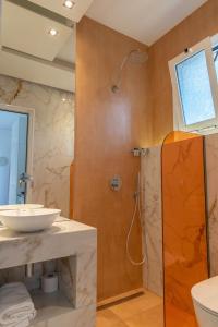a bathroom with a sink and a shower at Studios Filipidis in Chrysi Ammoudia