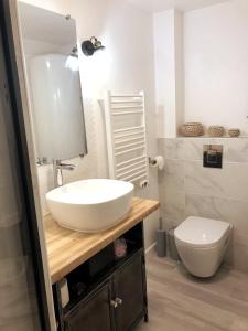 a bathroom with a white sink and a toilet at Les Hauts des Caps in Boulogne-sur-Mer