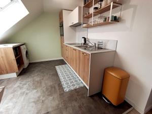 a small kitchen with a sink and a counter at Les Hauts des Caps in Boulogne-sur-Mer