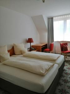 Ένα ή περισσότερα κρεβάτια σε δωμάτιο στο Landhotel Reckenberg