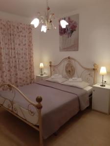 a bedroom with a large white bed with two lamps at Villa Claudia in Fažana