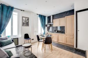 a kitchen and living room with a table and chairs at Suite Paris, Tour Eiffel, Champs Elysées in Paris