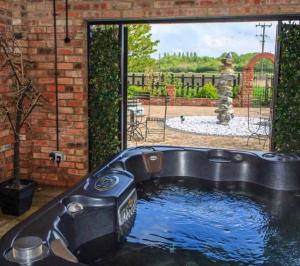 a hot tub in a backyard with a fountain at Lincoln Holiday Retreat Lodge with Private Hot Tub in Lincoln