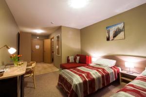 Postel nebo postele na pokoji v ubytování Dzintars Hotel
