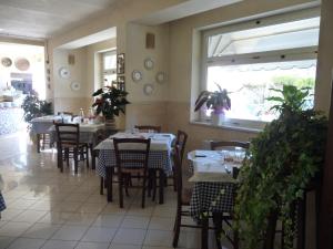 CassineにあるPasseggeri Club Houseの窓のあるレストラン(テーブル、椅子付)