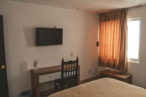 TV a/nebo společenská místnost v ubytování Hotel Latino