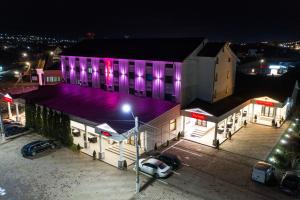 a building with purple lights on it at night at Hotel Polaris in Suceava