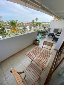 a balcony with two chairs and tables on a balcony at Apartamento Vista Mar 410 in Port d'Alcudia