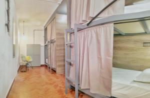 a room with two bunk beds and a wooden floor at Draft Hostel & Rooms in Lisbon +102 photos