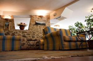 a living room with three chairs and a table at Hotel Danila in Portoferraio