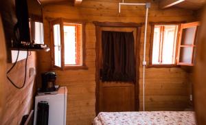 a room with a door and a bed in a cabin at Casutele Deny Băile Figa cu aer condiționat in Beclean
