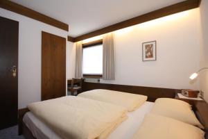 เตียงในห้องที่ Apartments Residence Alta Badia