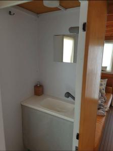 a bath tub in a bathroom with a mirror at HouseBoat Cagliari in Cagliari