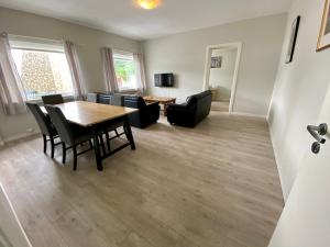 a living room with a table and chairs at Åndalsnes Sentrum Apartment No1 in Åndalsnes