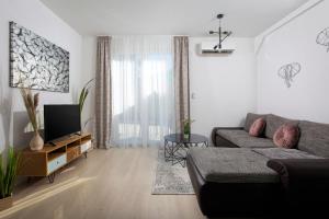 a living room with a couch and a tv at Apartment Antoni 2 in Podstrana