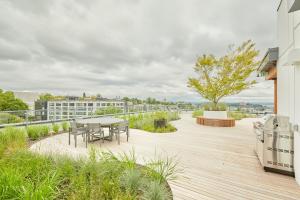 a wooden deck with a table and chairs on a building at Sonder at Solis in Seattle