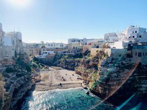 a view of a beach with buildings and the water at Dimora Anvi - Relax Fronte Mare in Polignano a Mare