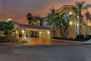 a hotel with palm trees in front of a building at La Quinta by Wyndham Pinellas Park St Peterburg Clearwater in Pinellas Park