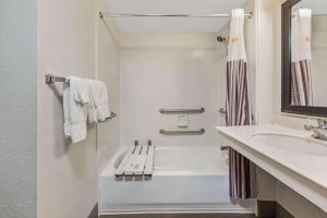 a bathroom with a shower, sink, and tub at La Quinta Inn by Wyndham Miami Airport North in Miami