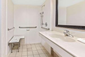 a bathroom with a sink, toilet and bathtub at La Quinta Inn by Wyndham Miami Airport North in Miami
