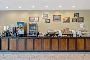 a restaurant with a counter with a food at La Quinta by Wyndham PCB Coastal Palms in Panama City Beach