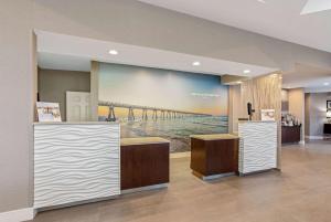 a large painting of a pier on a wall at La Quinta Inn & Suites by Wyndham Panama City in Panama City