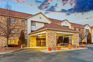 a large house with a driveway in front of it at La Quinta by Wyndham Milwaukee Delafield in Delafield