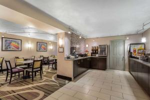 a lobby with a restaurant with a table and chairs at La Quinta Inn by Wyndham Binghamton - Johnson City in Johnson City