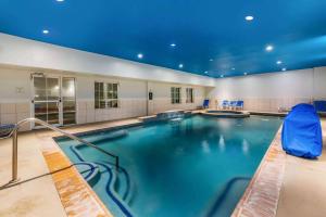 a large indoor pool with blue lights on the ceiling at La Quinta by Wyndham Orange in Orange