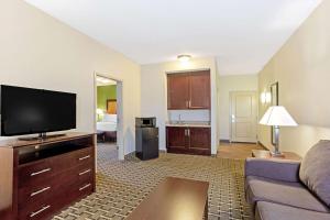 a living room with a couch and a flat screen tv at La Quinta by Wyndham Lancaster in Lancaster +3 photos