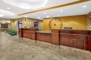 a lobby with a large clock on the wall at La Quinta by Wyndham Dickinson in Dickinson +44 photos