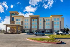 a large building with a car parked in a parking lot at La Quinta by Wyndham Pecos in Pecos