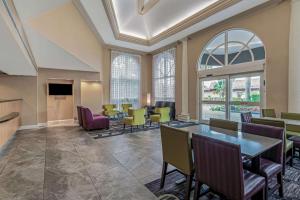 a large lobby with a table and chairs at La Quinta by Wyndham Naples Downtown in Naples