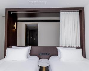 Säng eller sängar i ett rum på CitiGO Hotel (Shanghai International Tourist Resort)