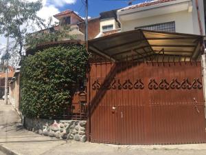 una puerta roja delante de una casa en Mini departamento cómodo, en Cuenca