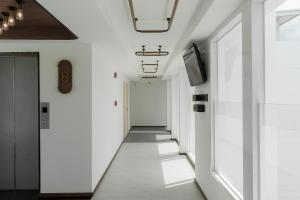 a corridor in a building with white walls at Hotel Amber Sukhumvit 85 in Bangkok
