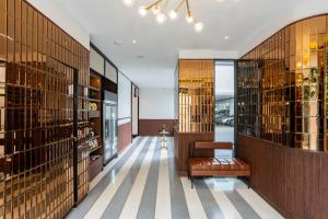a wine tasting room with a bench and a chandelier at Hotel Amber Sukhumvit 85 in Bangkok