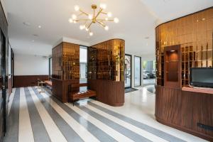 a large room with a chandelier and a tv at Hotel Amber Sukhumvit 85 in Bangkok
