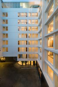 an external view of a building with windows at Hotel Amber Sukhumvit 85 in Bangkok