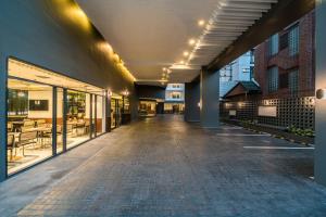 an empty hallway of a building with glass windows at Hotel Amber Sukhumvit 85 in Bangkok