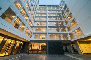 an external view of a large building with windows at Hotel Amber Sukhumvit 85 in Bangkok