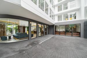 an empty building with glass windows and a couch at Hotel Amber Sukhumvit 85 in Bangkok
