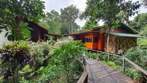 a house with a wooden walkway in front of it at Bilit Adventure Lodge in Bilit