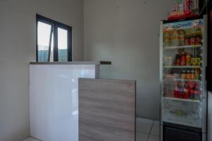 a refrigerator in a room with drinks in it at RedDoorz near Stasiun Tawang Semarang in Semarang