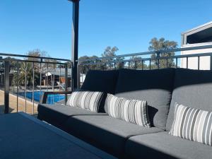 
a living room filled with furniture and a pool at Bundalong Villas in Bundalong

