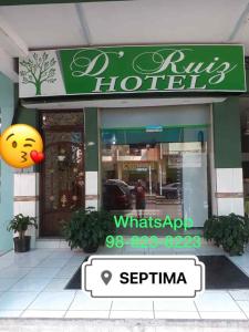 a store front of a hotel with a smiley sign in front at D’ RUIZ HOTEL in Quevedo +28 photos