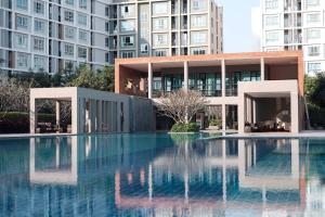 a swimming pool in front of a building at D Condo Sign Chiang Mai R628 in Chiang Mai