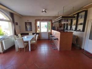 a kitchen and dining room with a table and chairs at Pensiunea Chrisland in Oradea