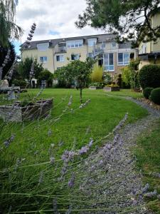 a garden with purple flowers in front of a building at Landhotel Saar-Mosel in Tünsdorf